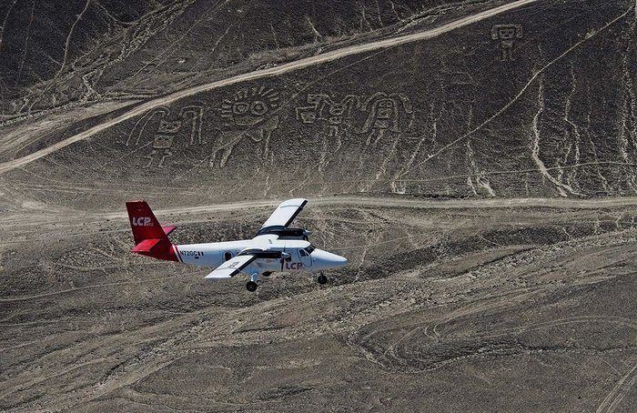 Plane Flying Over Paracas Family Nazca Lines at Pal