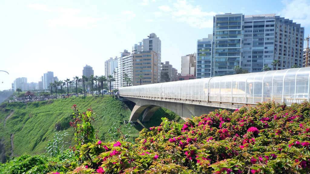 Skyscrapers and skyline overlooking coast and flower garden next to bridge in Miraflores Lima Peru - how to Miraflores 