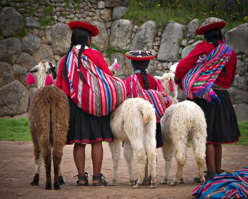 Local Peruvian village people with alpacas