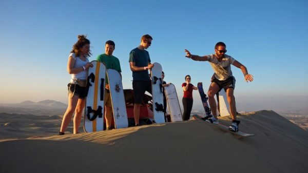 People having fun sandboarding