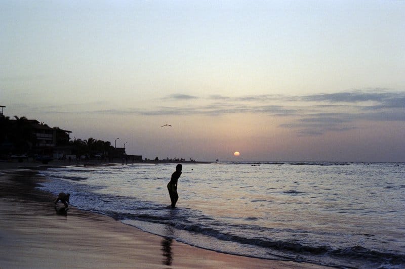 Beach mancora at night sunset man paddling