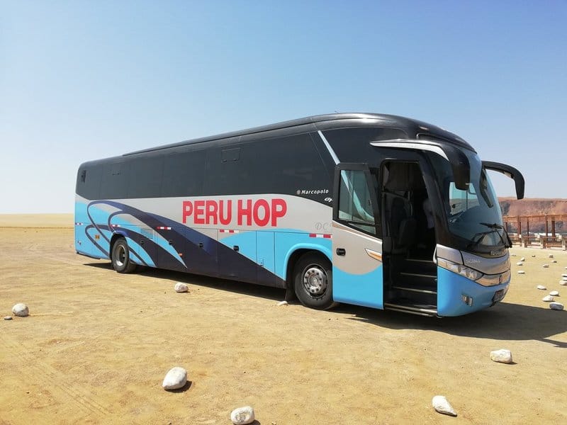 Peru Hop bus to Lake titicaca tours stopped door open sunny day desert paracas