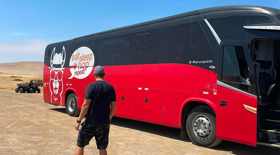 Traveler next to Peru Hop bus